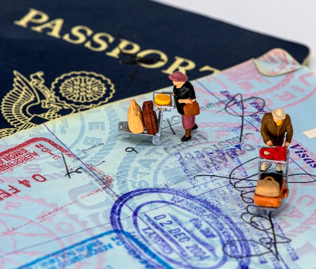 passport-and-e-2-visa-guide-with-two-people-carrying-trolley-full-of-suitcases