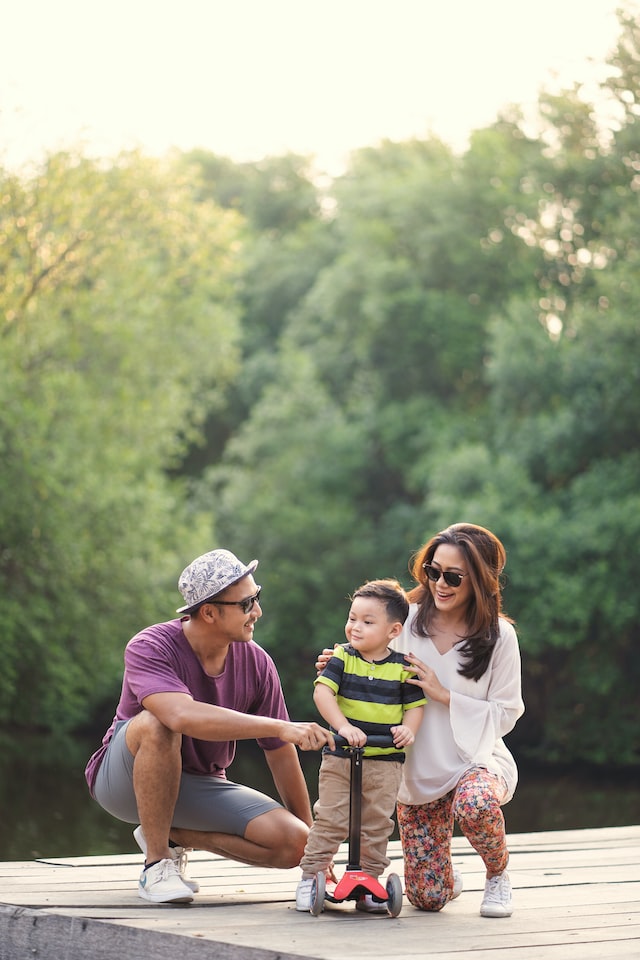 A family of three laughing together